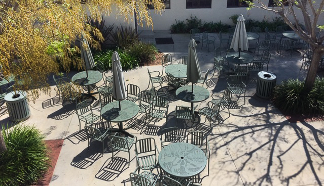 The usually-crowded tables outside the Commons sit vacant during the cancellation of school.