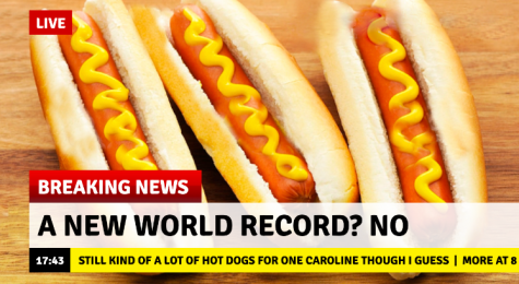 A fake news screenshot with the headline "A New World Record? No" and the ticker saying "Still kind of a lot of hot dogs for one caroline though." The background photo is three hot dogs. 