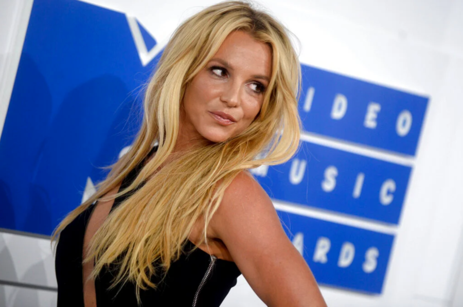 Britney Spears posing for cameras.	