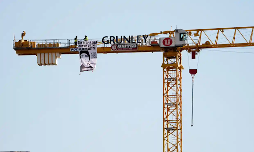 Manuel Oliver, father of a teenager killed in the Parkland school shooting, holds a banner calling Biden to take action on gun violence. (Photo Credit: Stefani Reynolds/AFP/Getty Images)