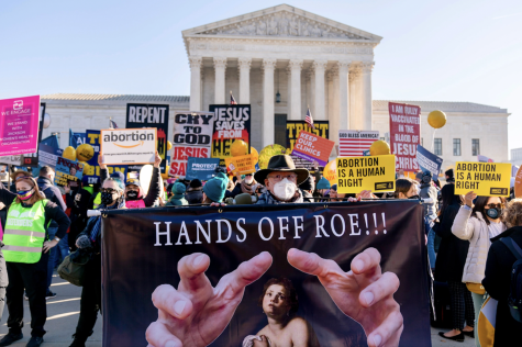 Stephen Parlato holds a sign with the words, “Hands Off Roe,” outside of the U.S. Supreme Court on Dec. 1, 2021, protesting a 2018 law that would ban abortions after 15 weeks of pregnancy.