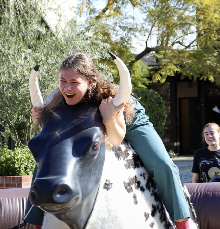 A student riding a mechanic bull from ASD 2020.