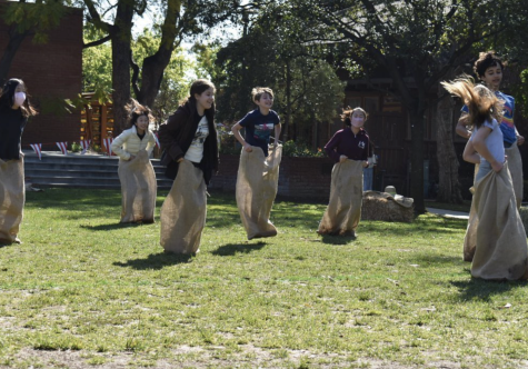 Lower Schoolers participate in sack racing to win an inflatable animal shaped headband.