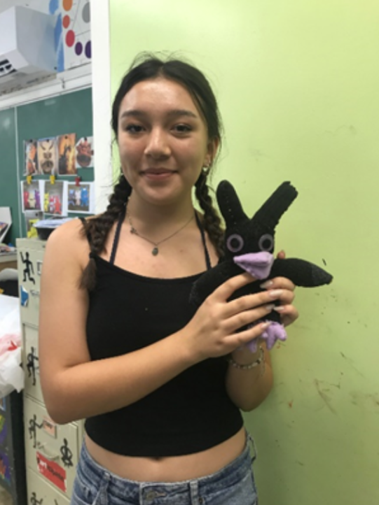 Counselor Ellie L. and her handsewn stuffed animal.