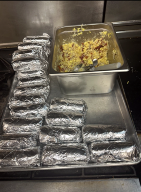 (Lexi E.) Finished breakfast burritos waiting to be put out.
