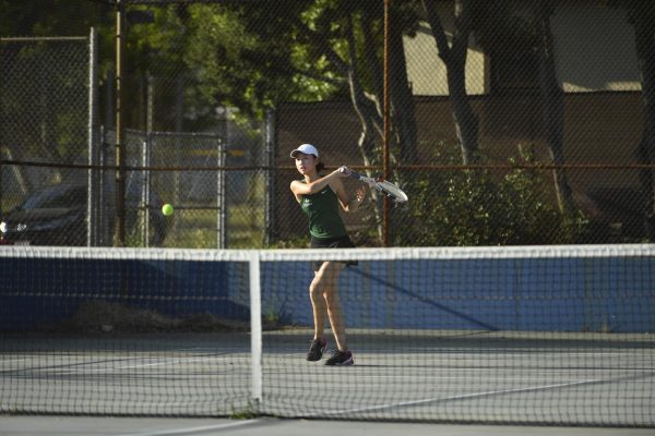 Jennifer L. 25 hits the ball back in a tennis match. This year, Jennifer won the Prep League Singles title and was crowned Singles MVP.