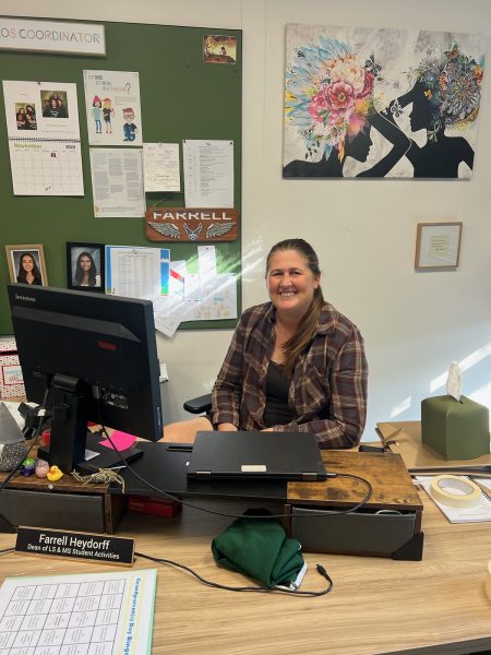 Ms. Farrell Heydorff, Dean of Lower and Middle School Student Activities, sitting at her desk.