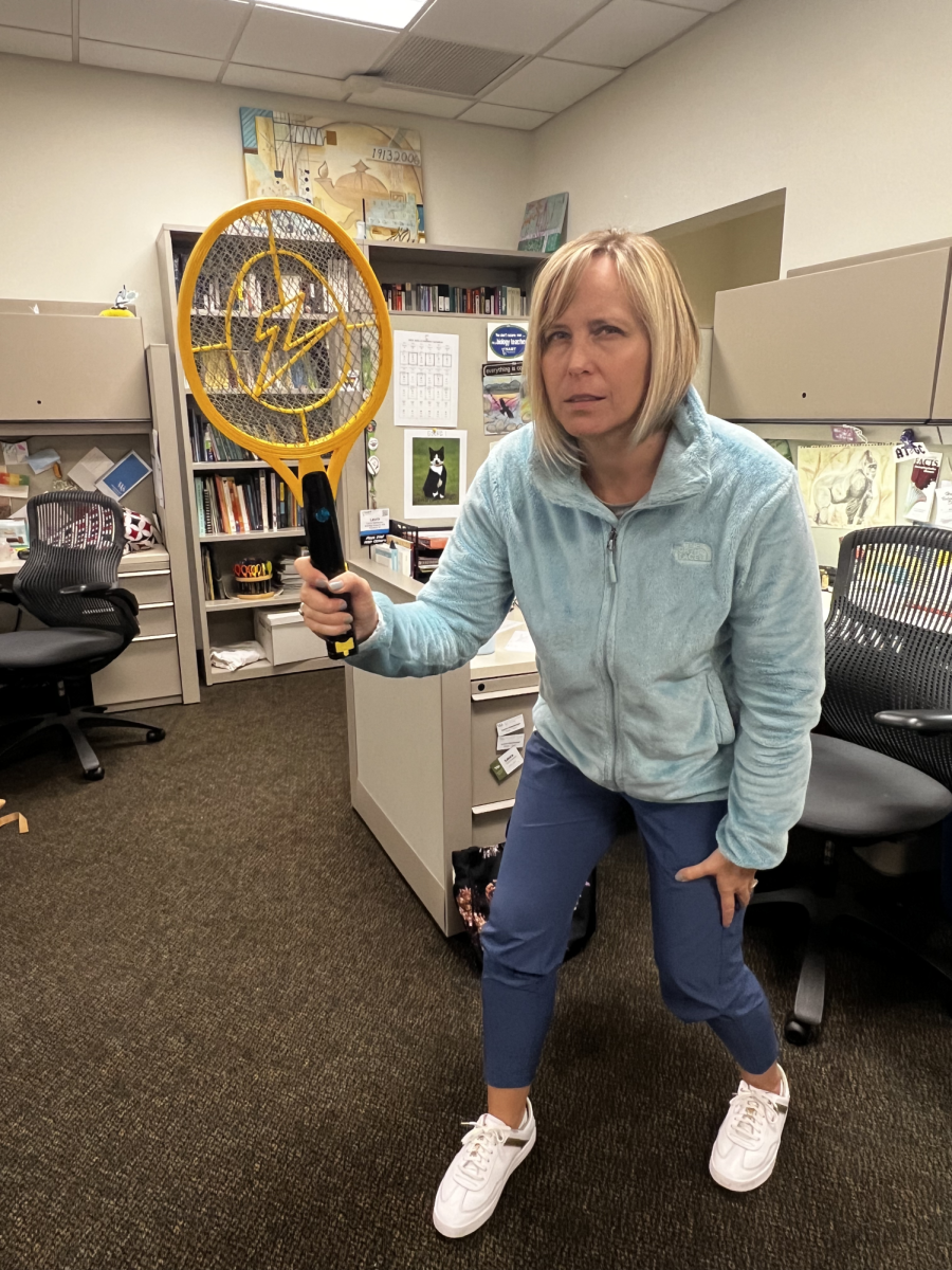 Upper School Biology teacher Ms. Hatchman, wielding Dr. Udells mosquito zapper. 