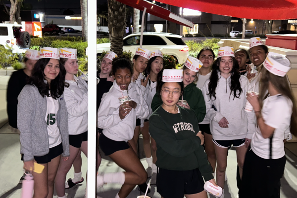 Westridges Varsity Soccer team stands outside of In-N-Out, while wearing their hats.