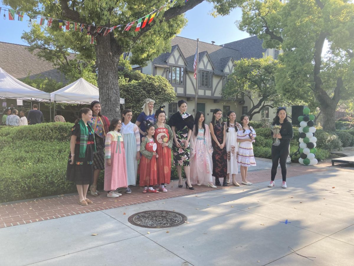 (All participants of the International Fashion Show take a picture together after starting off the Westridge Night Market. Credit Aceley P. ’27)
