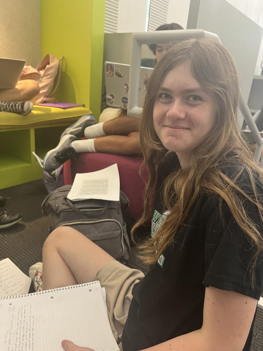 Piper H.-M. '28 doing homework at the library with her friends. About her first ever year in high school, she said, "The schedule's not really a big deal. I think it's okay and I like it."