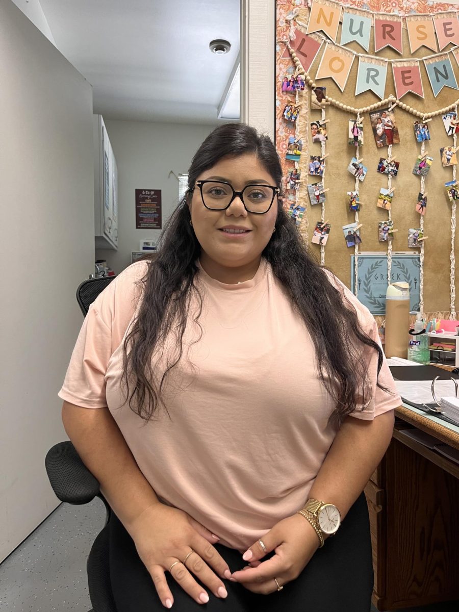 Lorena Beltran in her newly decorated office. She put up several photos of her dog and family and colorful borders around the room.