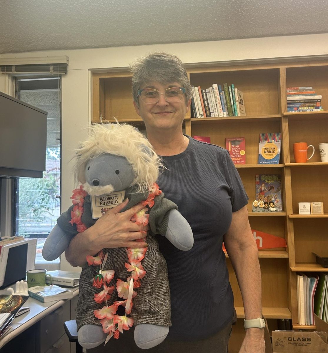 Dr. Lacoss poses with her light blue bear made in Albert Einstein’s likeness.