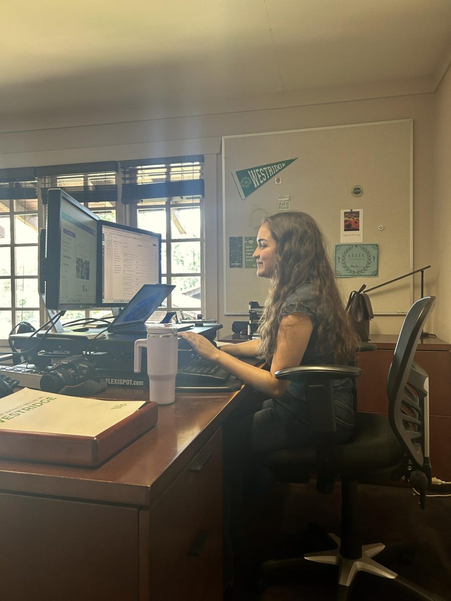 At her desk in Pitcairn, Ms. Diaz works on design and marketing for Westridge.  Photo Credit: Josie S-J. ’27
