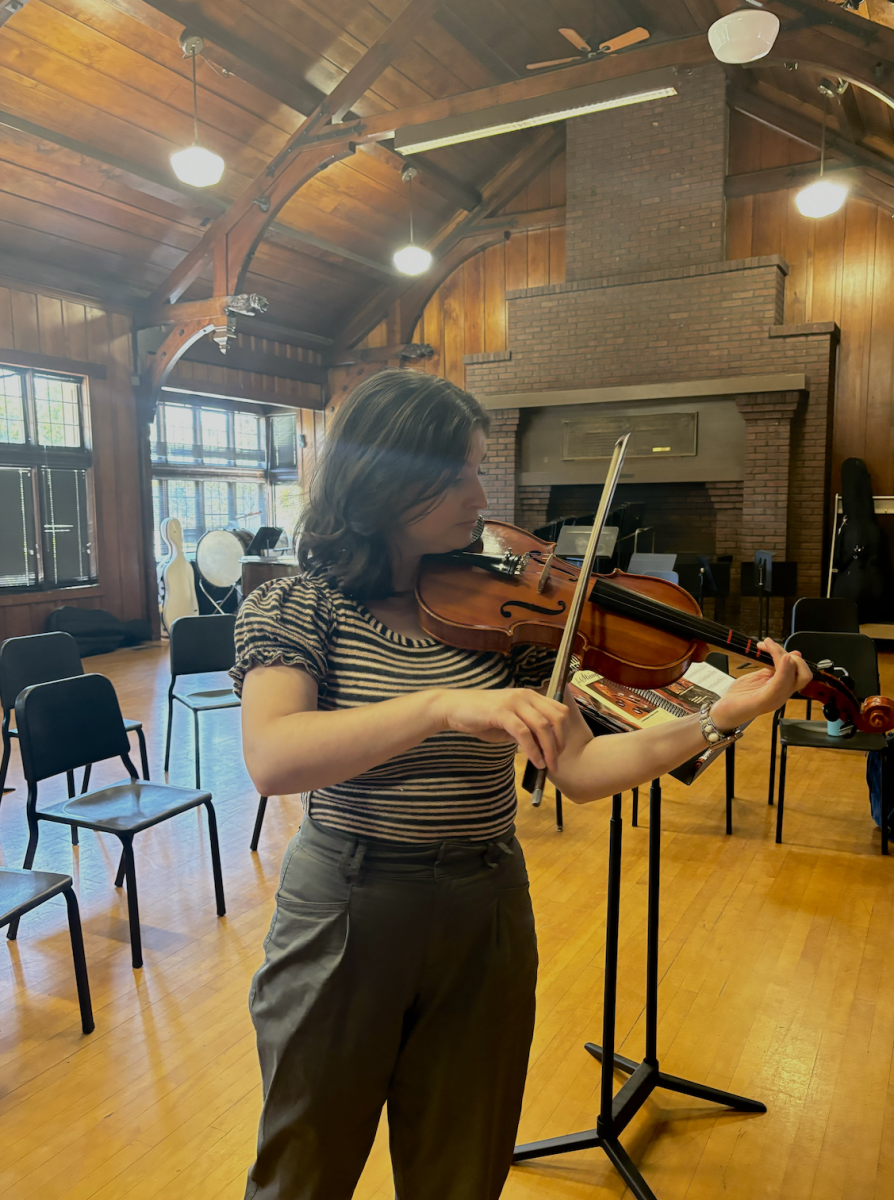 Ms. Rachel Counihan playing her violin in the Braun Center after her students leave. 
