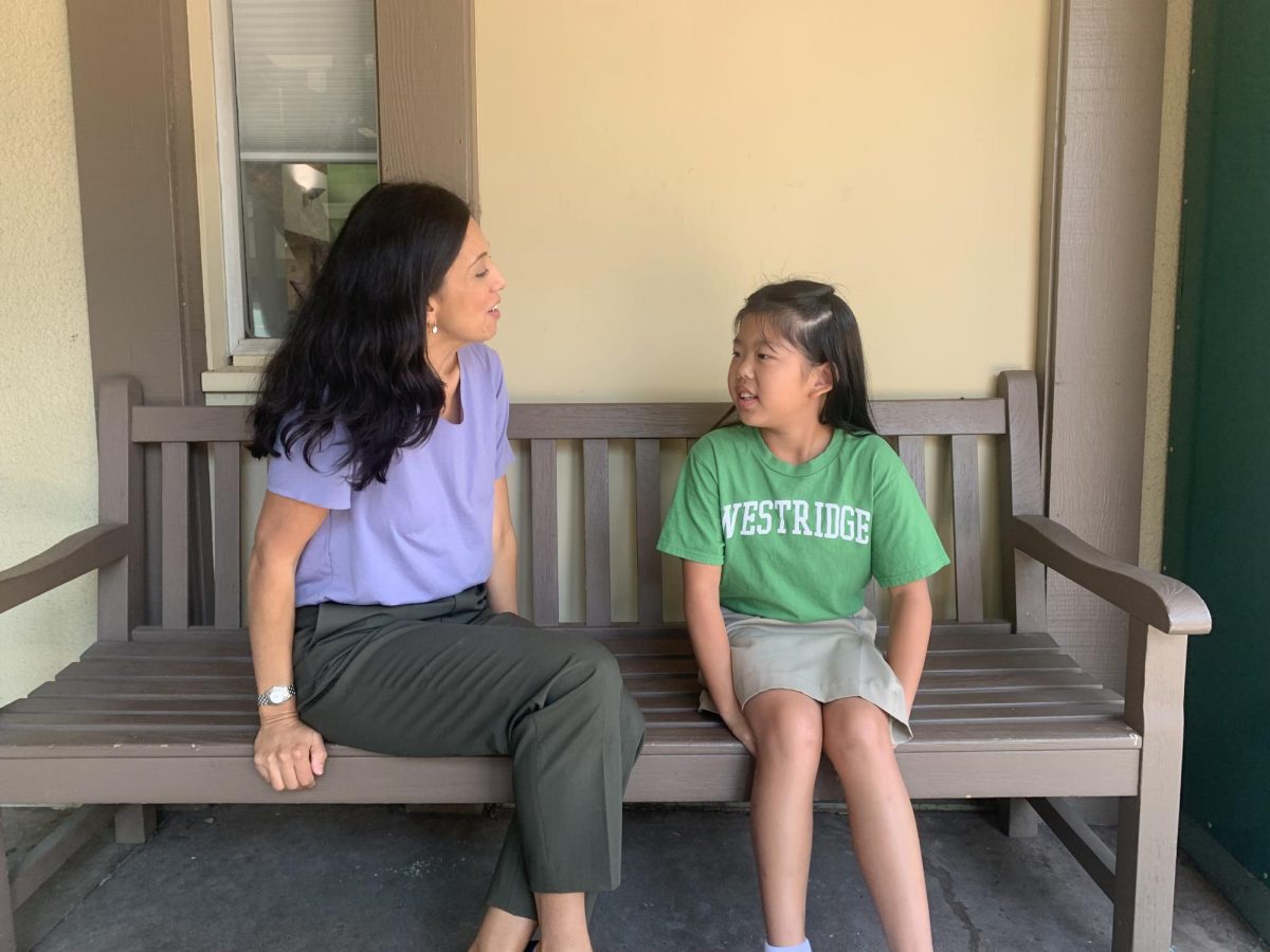 Ms. Quezada talking to one of her fourth grade students, Abby C.
