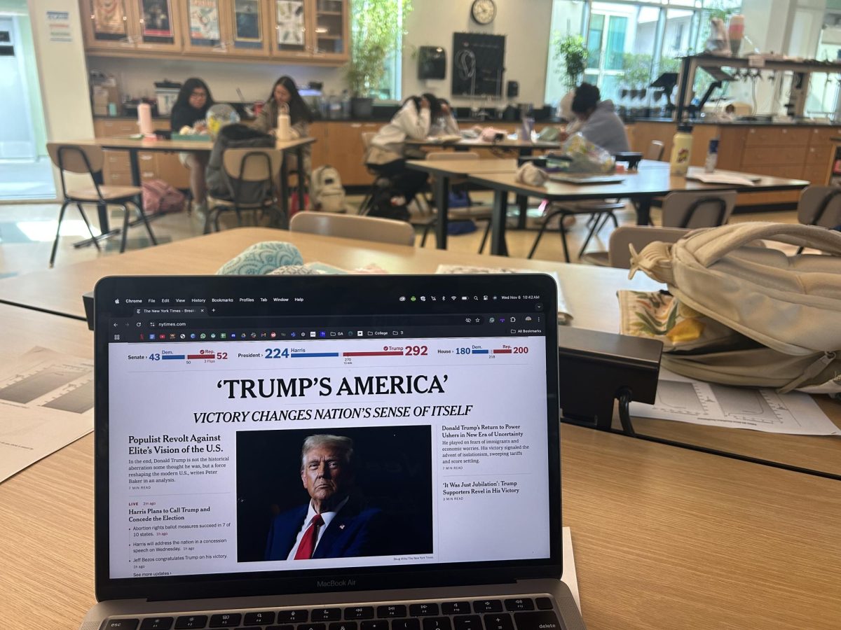 The New York Times' homepage, blasts "Trump's America." In the back, students work somberly in their Environmental Science and Engineering course, after their teacher, Ms. Michelle Amos, altered her cirriculum to serve as a student work-day, cognizant of student emotions after the election results came out.