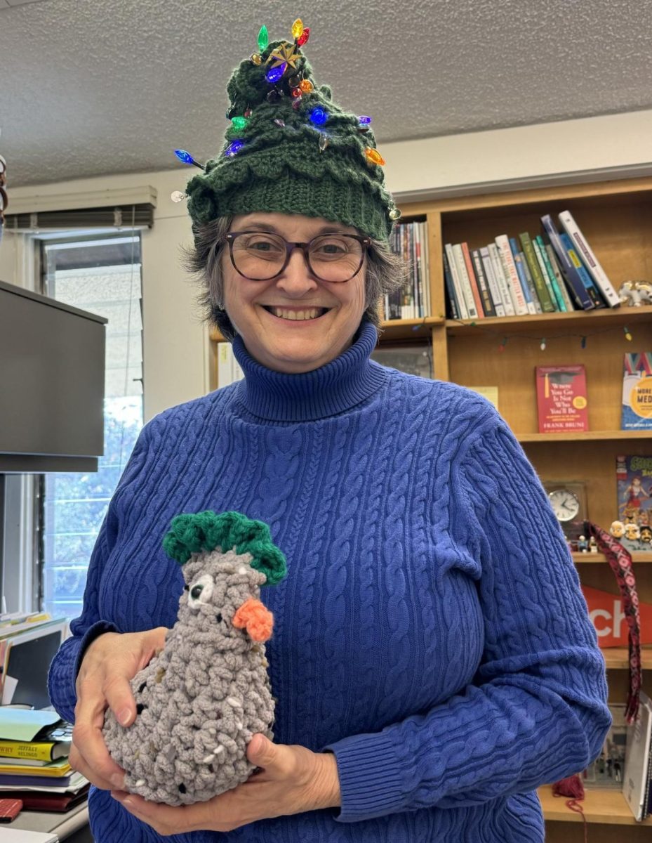 Dr. Lacoss shows off “Team CoCo’s Emotional Support Chicken” while sporting her Christmas tree hat.
