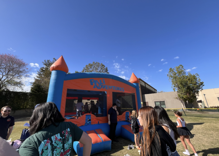 Students jump inside the bouncy house on Frank Field.