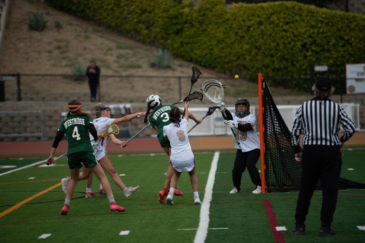 An intense moment taken during the Quarter Final CIFs game against Oaks Christian, as a Westridge player shoots while under immense defensive pressure.