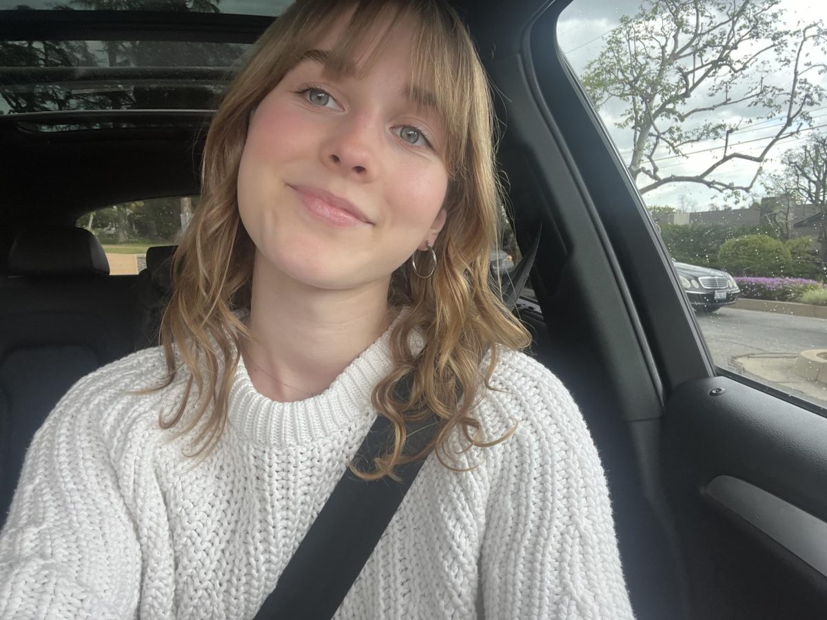 Sydney S. '25 posing for a picture in the car.