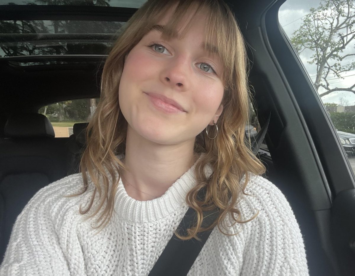 Sydney S. '25 posing for a picture in the car.
