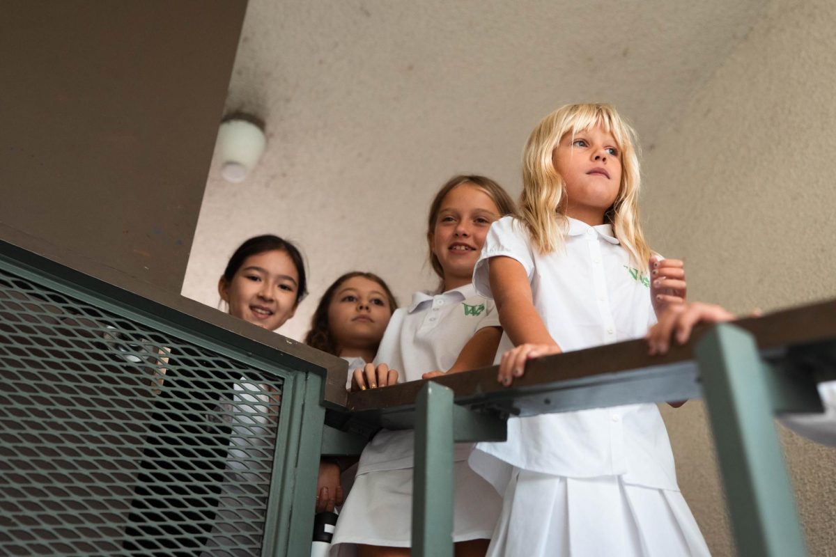 After watching their fifth and sixth-grade counterparts parade past in blue and yellow, fourth graders eagerly wait for their cue to sprint over to the gym for Greek and Roman initiation (in true lower-school fashion).
