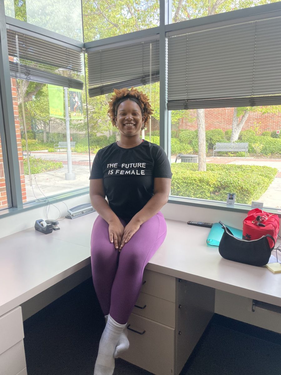  On a sunny Monday morning, Ms. Jackie wears her “The Future is Female” shirt as she prepares to lead an energetic warm-up with her advanced dance class.