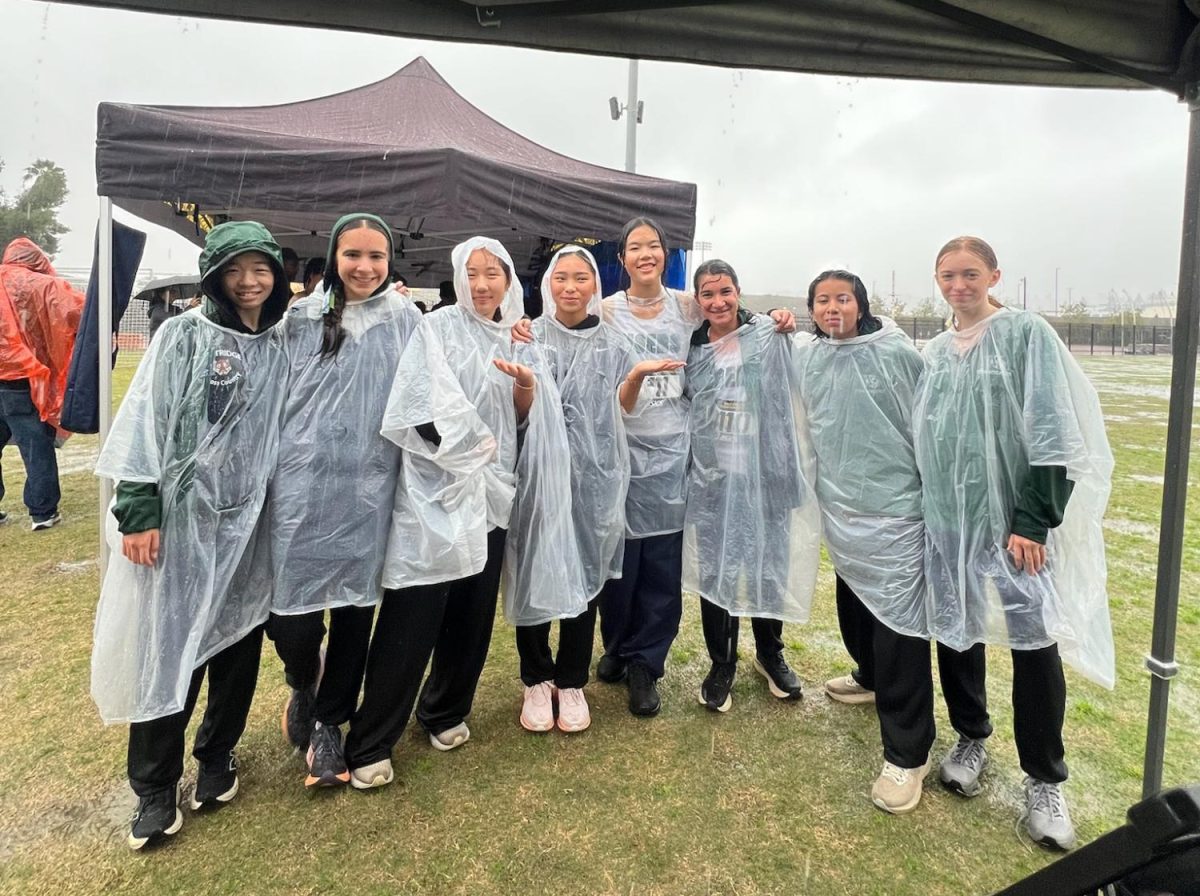 The team on the day of CIF Prelims getting soaked in the rain.