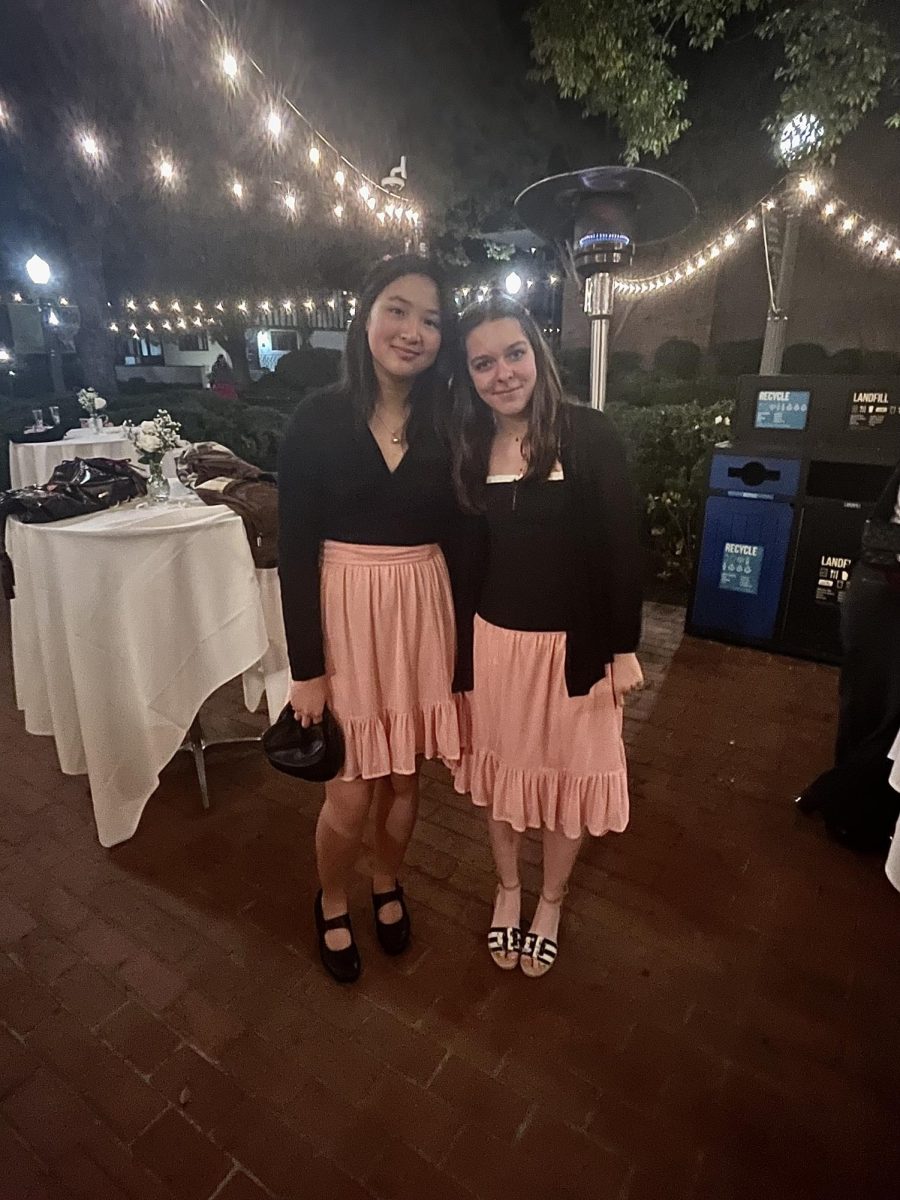 Katherine D. '28 and Skylar R. '28 unintentionally match in pink dresses and black cardigans.