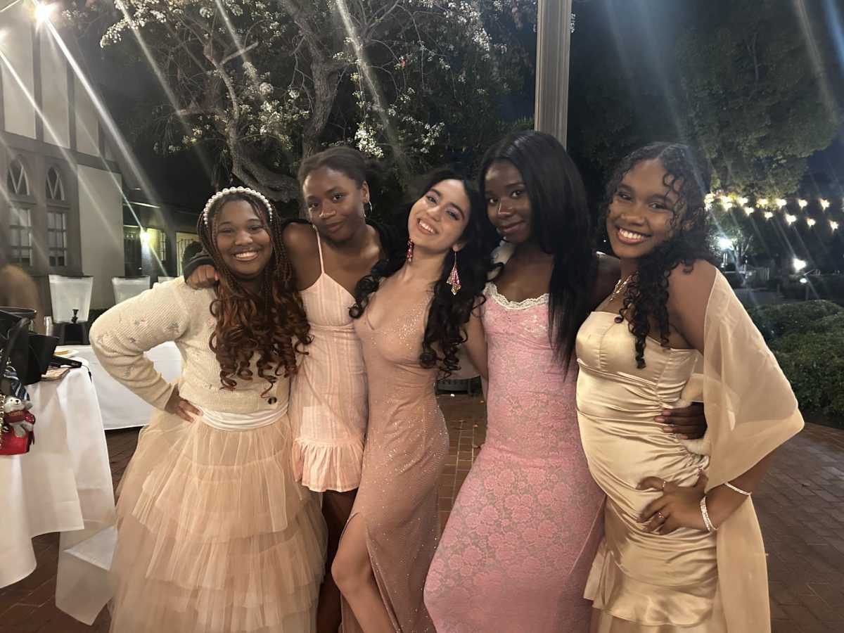 Seniors Zoë T., Irene A., Avani L., Slone C., and Miceala R., display their Pretty in Pink themed coordinated outfits.