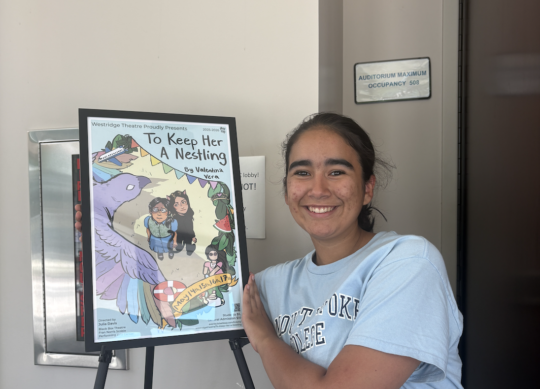 Valentina V. posing with the poster for “To Keep Her a Nestling” displayed outside the PAC theatre.