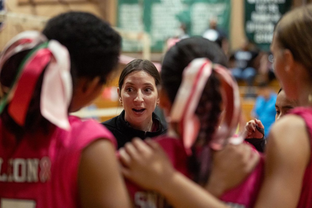 Jenna Wong coaches her Varsity Volleybal team during Dig Pink night.